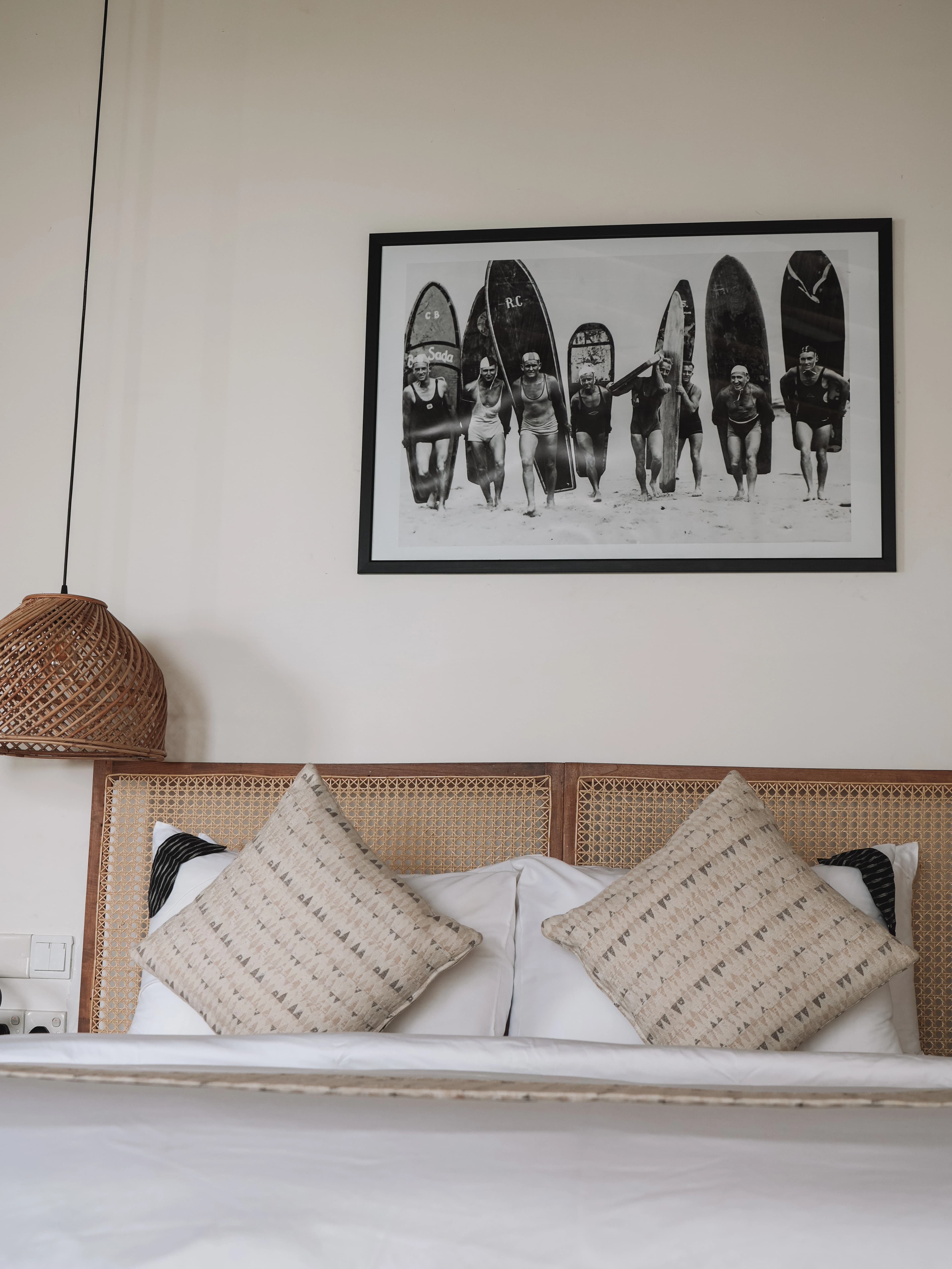 Rattan headboard, woven lamp and surf photograph in the Rock Suite at Abode by the Beach, Sri Lanka